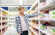 © Rudenko - young man buys juices and milk for home