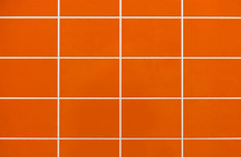 Orange Ceramic Tile On The Wall In The Bathroom. Background From Orange Tiles.