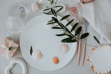 Canvas Print - Flat lay wedding Festive table summer setting with golden cutlery, olive branch, porcelain plate. restaurant menu concept.