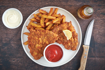 Wall Mural - Original Schnitzel mit Bier und Pommes top view closeup 