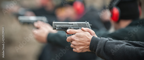 Fotografía Close-up view of shooter practice handgun shooting in row group