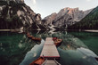 © Cavan Images - Rowboats moored in lake against mountains range
