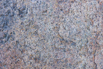 Wall Mural - Granite texture close up. Granite rocks with porous surface. Background from solid stone. Pattern with natural material