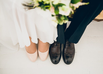 Closeup of bride and groom's shoes