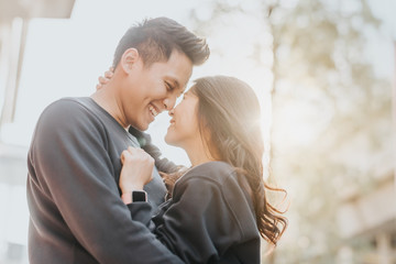 asian couple in love embracing outdoor