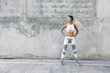 © Alena Ozerova - Fitness sport model in fashion sportswear posing over gray wall