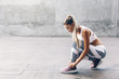 Leinwandbild Motiv Fitness sport woman in fashion sportswear doing workout over gray wall