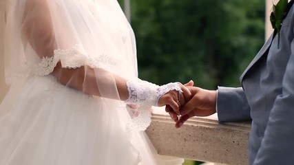 Wall Mural - Groom holding bride’s hand