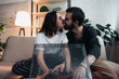 © LIGHTFIELD STUDIOS - beautiful couple kissing and putting vinyl record on record player in living room