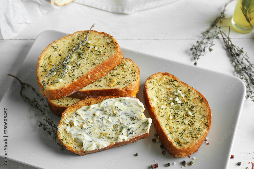 Tasty cut garlic bread on plate