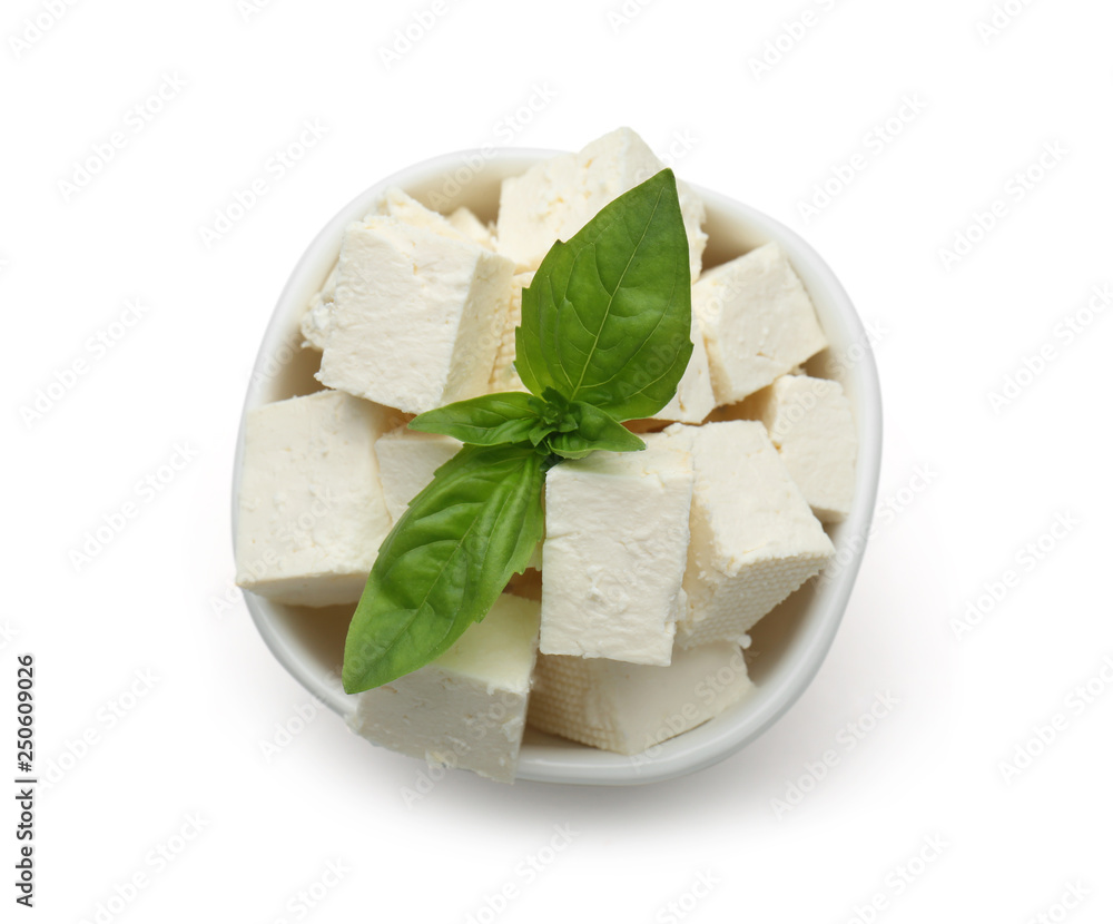 Bowl with tasty feta cheese on white background