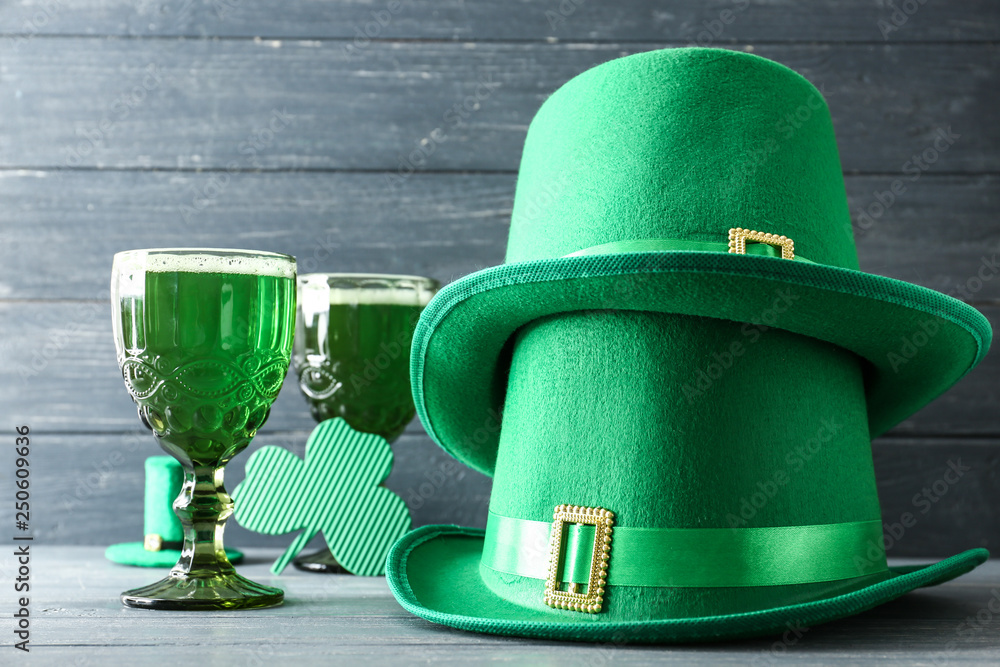 Leprechaun hats with green beer on wooden table. St. Patrick's Day celebration