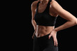 © Pixel-Shot - Sporty young woman on dark background