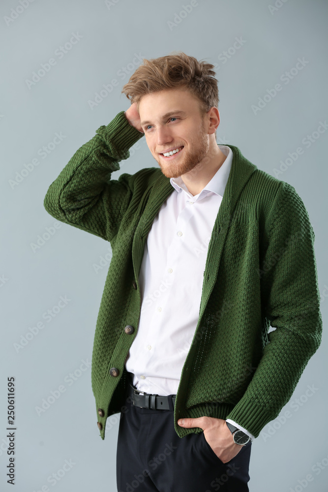 Fashionable young man on grey background