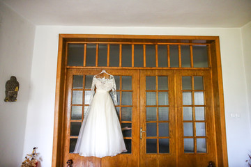 Bridal dress hanging on door