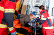© LIGHTFIELD STUDIOS - Paramedics transportating patient on gurney in ambulance car