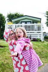 Two sisters playing outside there static holiday home cuddling and playing