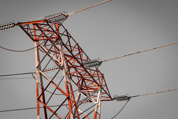 Power pylon array and details. Energy plant, red and white metal. Elctricity distribution grid, clean energy and local politics. National consumer supply for housing and cities. 