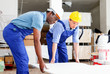 © JackF - Two male builders working at indoors building site