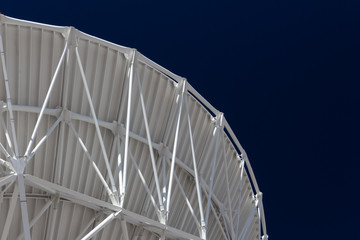 Wall Mural - very large array sweeping curve of a radio telescope antenna dish, white against a dark sky, science
