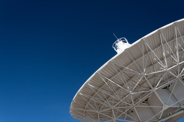 Wall Mural - very large array understructure of a radio telescope antenna dish pointing into a deep blue sky, cop
