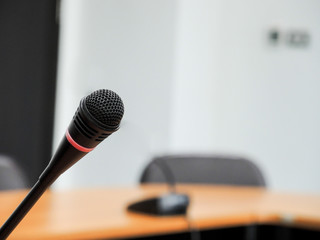 Close up microphone on stage in concert hall restaurant or conference room blurred background