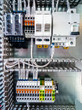 © Евгений Фисенко - Electrical background. Group of terminal connections,  protective automatic switches, electromagnetic relays and starters.