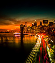 Must See When Visiting New York City. View Of Lower Manhattan And  Brooklyn At Sunset. Night Scene. Light Trails. City Lights. Urban Living, Travel, Real Estate  And Transportation Concept
