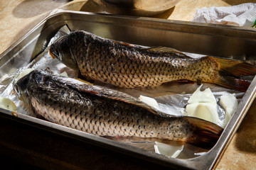 two big stuffed fish ready to cook on cooking foil