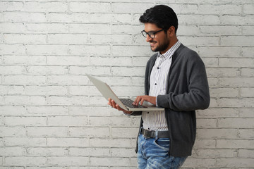cheerful programmer with laptop