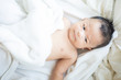 © themorningglory - Asian baby boy lying on white blanket morning wake up
