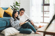 © Nattakorn - Lifestyle Asian couple man and woman talking working  spend time together at home, Asian couple family lifestyle concept
