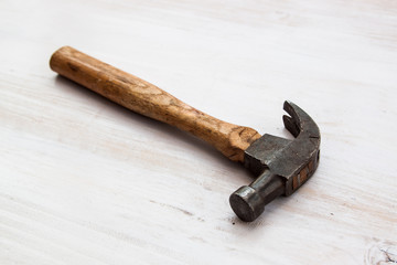 old and vintage hammer handle tool on the old wood background 