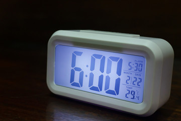 Digital alarm clock  6:00 close up image.