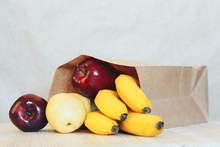 A Paper Bag With Purchases From The Store. Fresh Fruits On The Table.