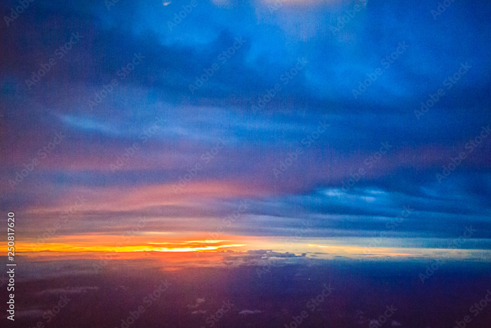 Dusk sky and cloud at morning dawn background. Vibrant colors of the sky with clouds from dusk till dawn. Dramatic evening cloudscape in the city. Twilight sky began to change from blue to orange.