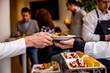 © Kira - waiter's hand passes a plate of potatoes in the hands of a man at catering event on some festive event, party or wedding reception