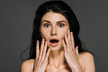 Wall Mural - beautiful shocked woman with freckles on face isolated on grey