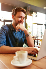 Wall Mural - Man work on laptop in cafe