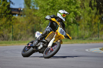 Motorcycle practice leaning into a fast corner on track