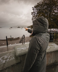 Woman Pointing Towards Lake