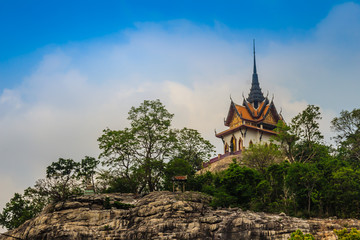 Beautiful white buddhist pavilion on the hilltop with blue sky background at Wat Phraputthachai temple, Saraburi, Thailand. This temple is public for entry and tourist can enjoy the 360-degree view.