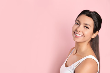 Wall Mural - Young woman with healthy teeth on color background. Space for text