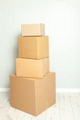 Wall Mural - Day moving. Delivery of goods, shopping. Cardboard boxes on gray wall background