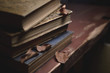 © Павел Абрамов - a stack of old vintage books on a red wooden table and dry leaves