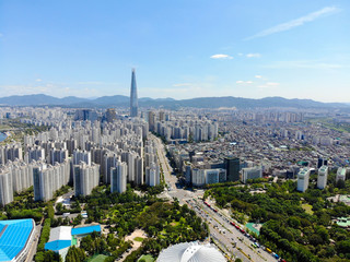 Aerial view cityscape of Seoul, South Korea. Aerial View Lotte tower at Jamsil.  View of Seoul with river and mountain. Seoul downtown city skyline, Aerial view of Seoul, South Korea, 08/20.2018