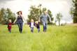 © Cavan Images - Happy family with children (2-3, 4-5, 6-7) walking in meadow