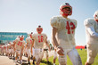 © Cavan Images - Teenage american football player (16-17) walking in field