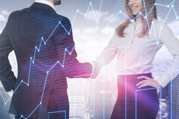 Wall Mural - Man and woman shaking hands in city, graph