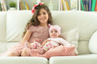 © aletia2011 - Portrait of two beautiful cute sisters posing in sofa at home